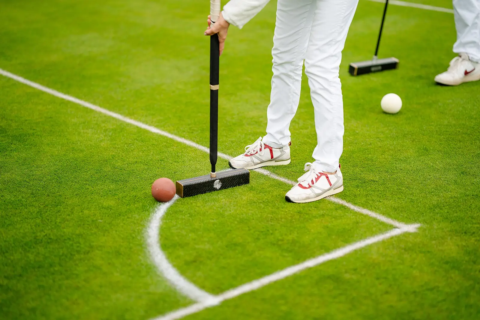 A six-wicket match in whites on the main lawn, mallet addressed to the striker's ball