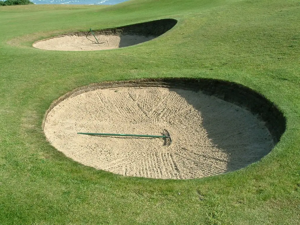Two deep pot bunkers cut into the fairway at the second, rakes laid across the sand