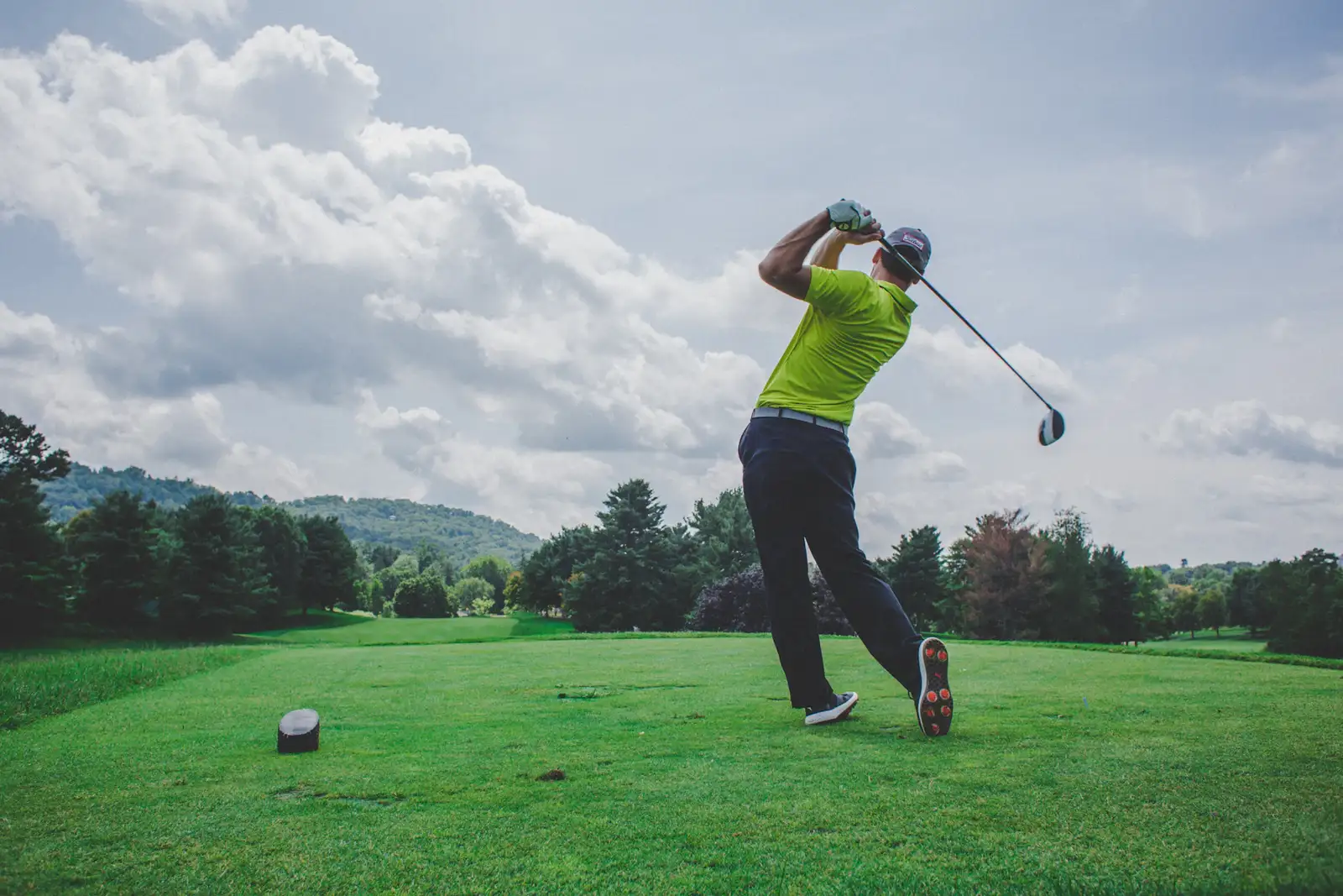 A member full into his approach at the sixth, the fairway opening beyond