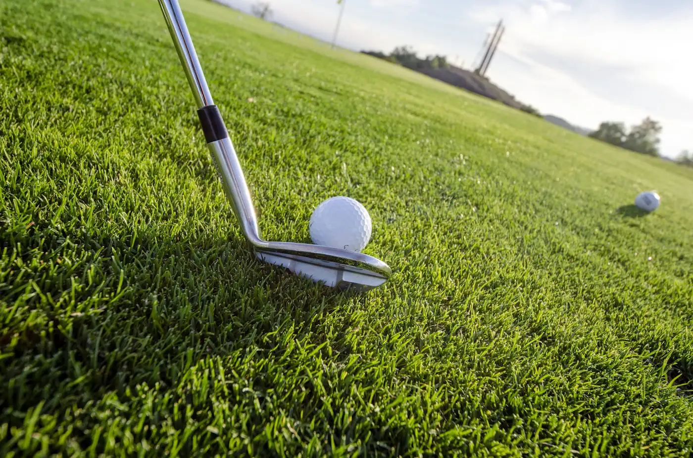 An iron behind a well-worn ball on the practice ground, the morning's work ahead