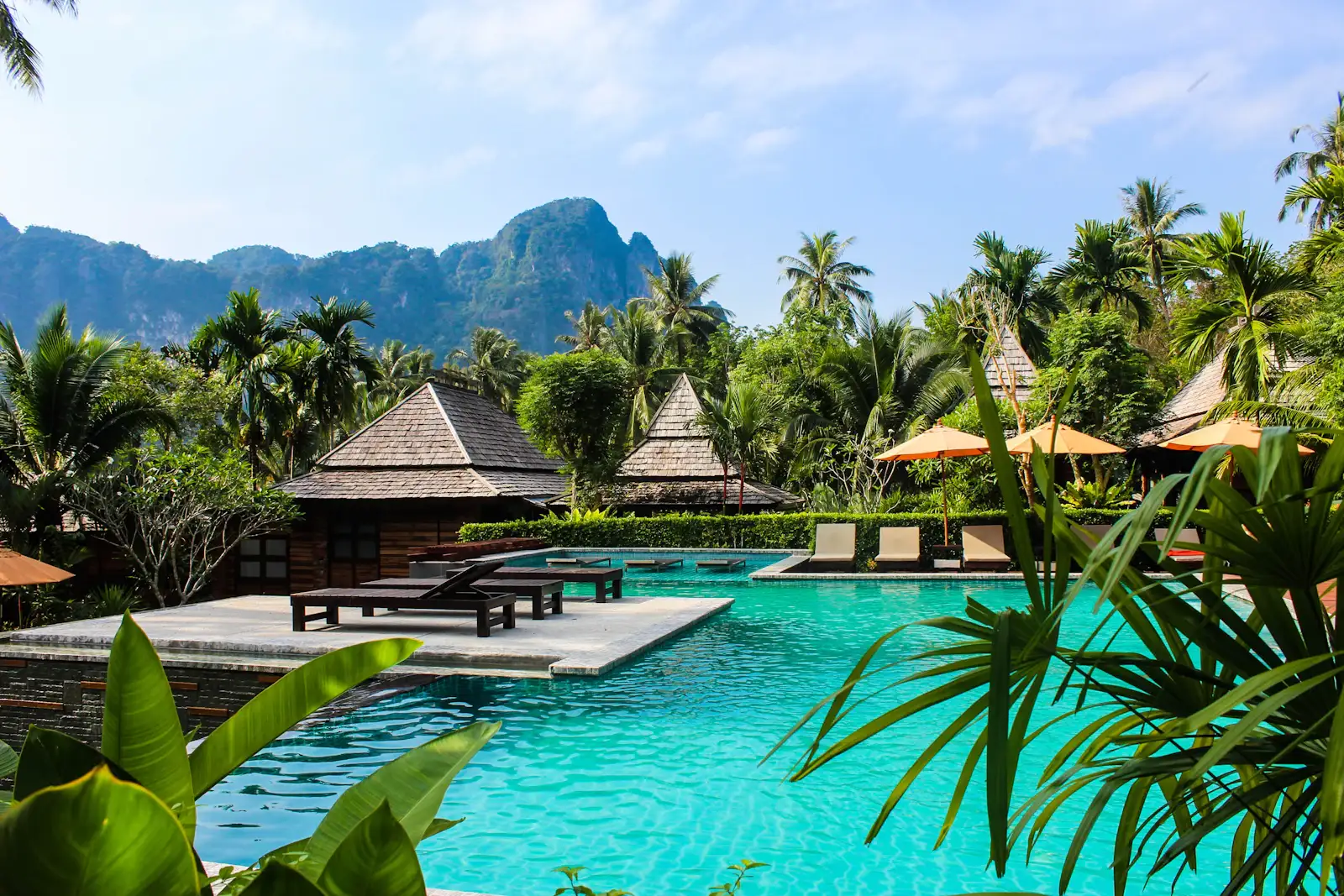 Lounge chairs and umbrellas along the family pool terrace in full summer