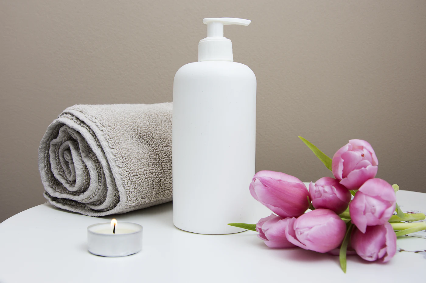 Folded towels, river stones, and a single orchid arranged in the Stillhouse Spa quiet room